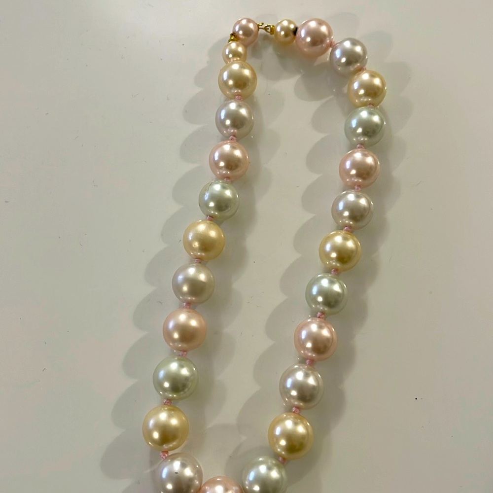 Pearl necklace…weighted… light colored pearls